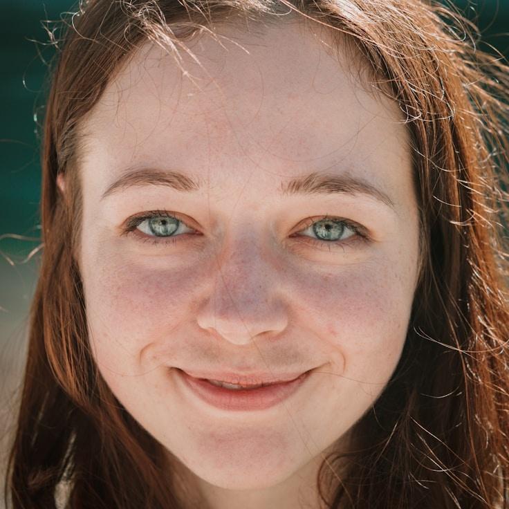 Aria Shah, Lead Design Curator at Still Brook Garden, reviewing corporate floral arrangements